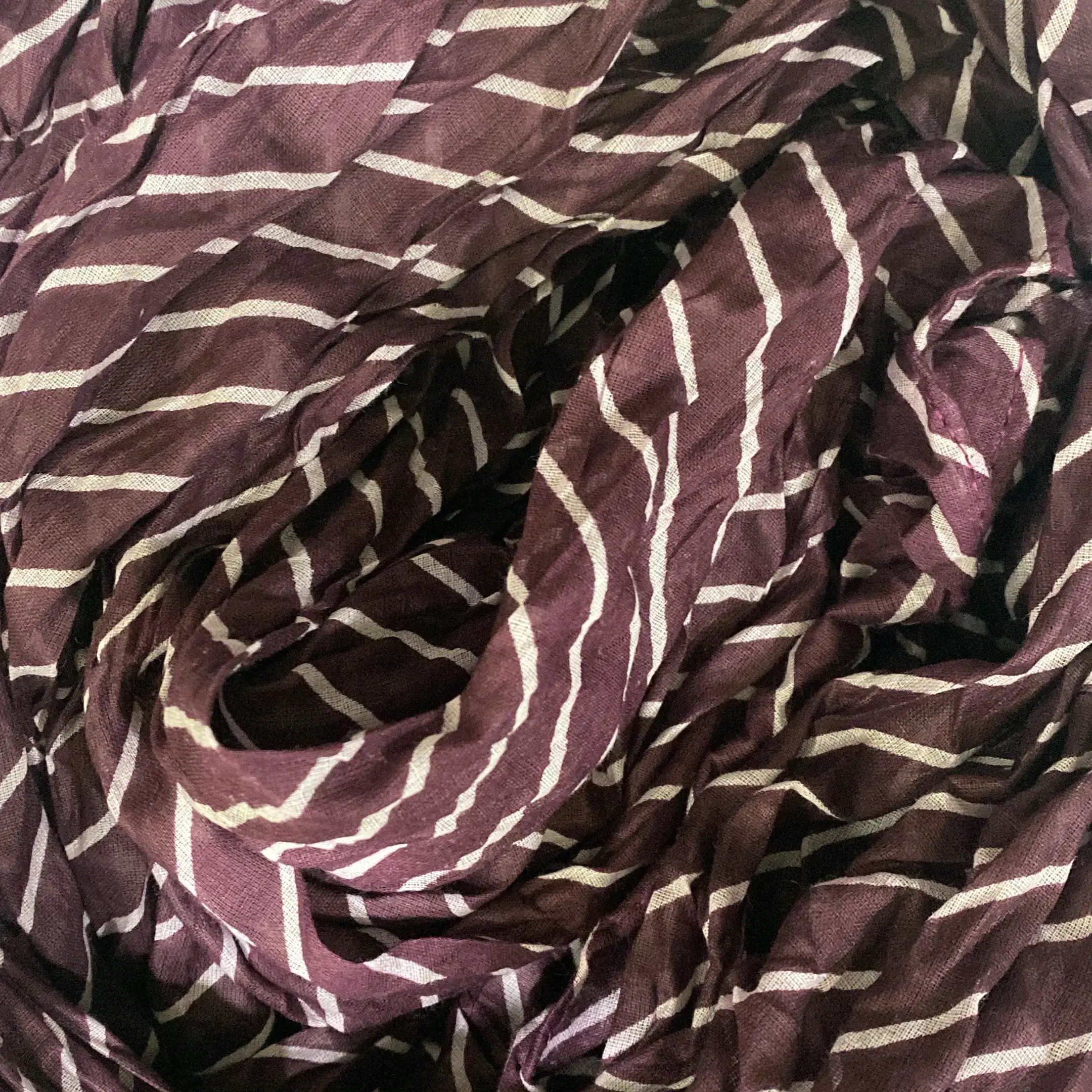 Scarves and wraps drape detail from a luxury fashion India label