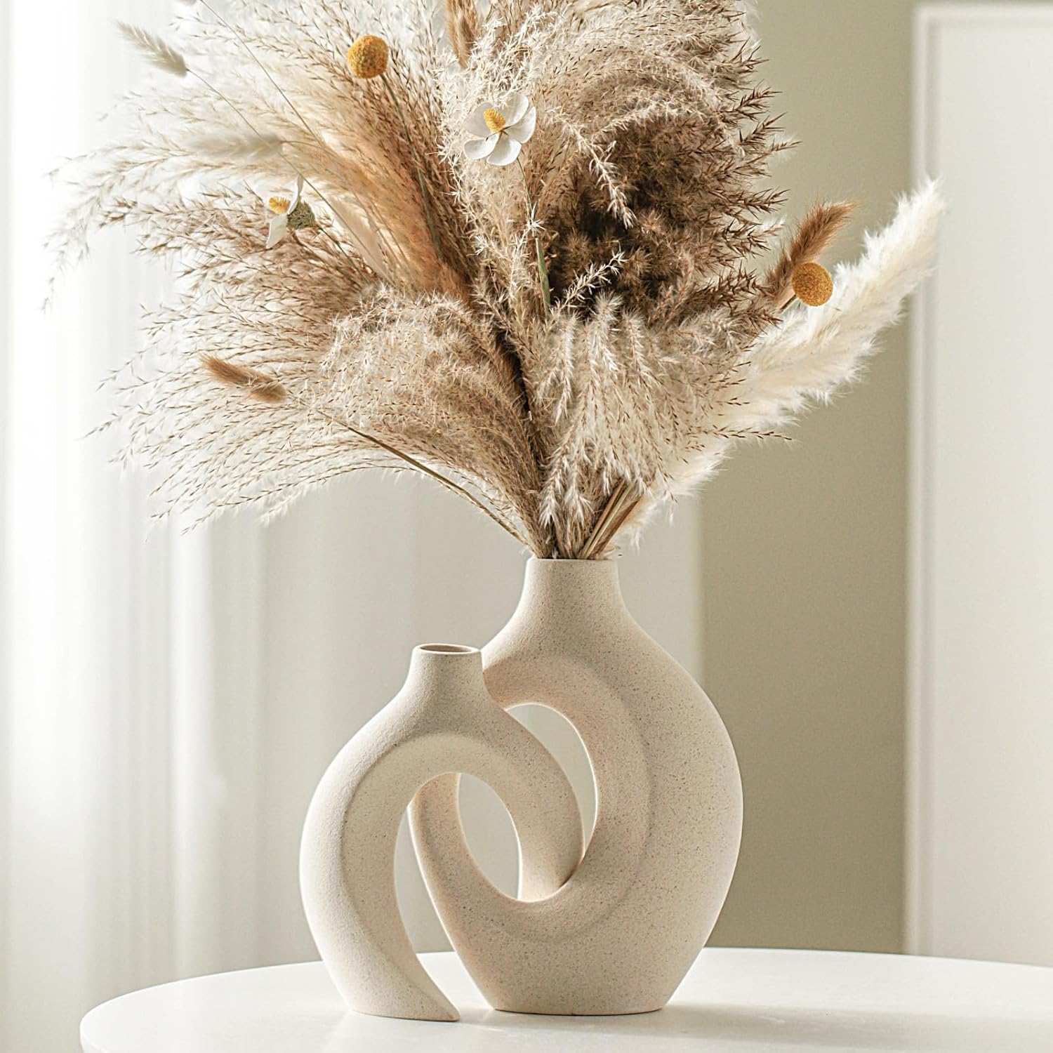 Home Decor Products — embroidered cushions, brass vases and candles styled by home decor exporter in Mumbai