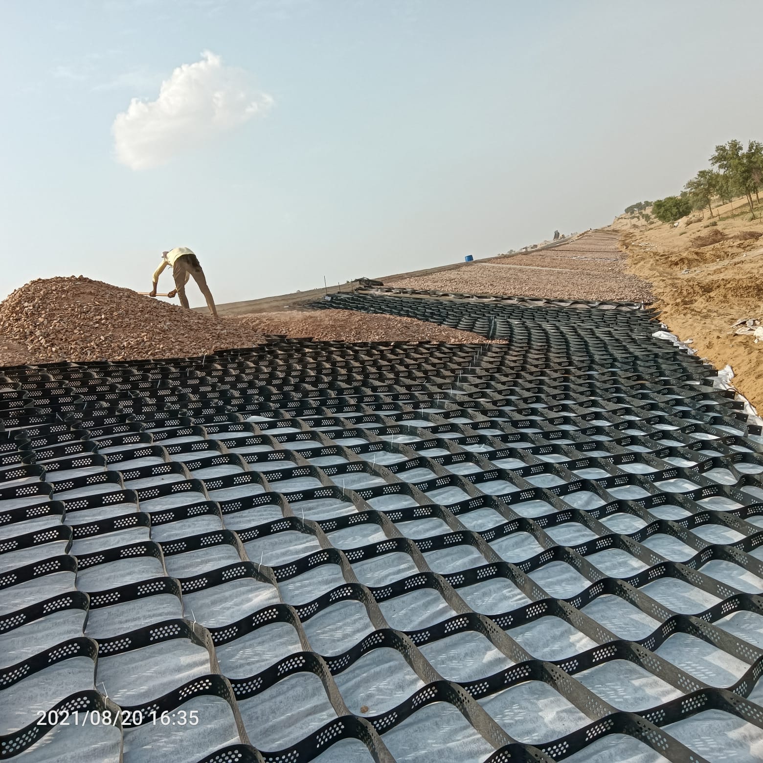 Reinforced soil slope works for valley side road