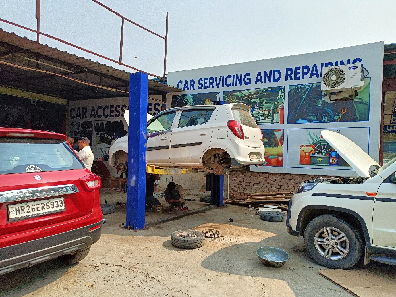 Car lifted on hydraulic bay for servicing and repairing at Car's IPS multi brand workshop in Bhiwadi