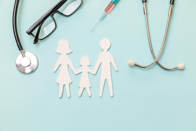 Family paper cut-out with stethoscope – best health insurance advice in Mumbai